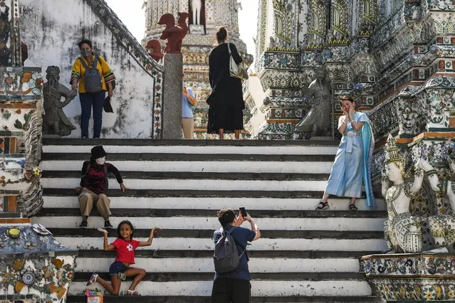 Tourists visit Wat Arun temple in Bangkok, Thailand on January 18, 2023. (Photo by Chalinee Thirasupa/Reuters)