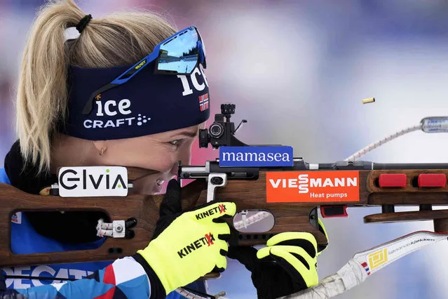 A spent cartridge pops out of the rifle of Marte Olsbu Roeiseland, of Norway, during warmup before the Women 7.5 km Sprint competition at the Biathlon World Championships in Oberhof, Germany, Friday, February 10, 2023. (Photo by Matthias Schrader/AP Photo)