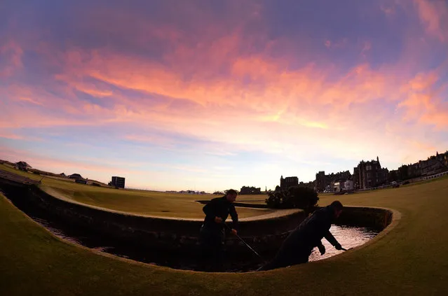 Green keeping staff prepair the Old Course as dawn breaks in St Andrews ahead of the Alfred Dunhill Links Championship at The Old Course on October 3, 2016 in St Andrews, Scotland. (Photo by Mark Runnacles/Getty Images)