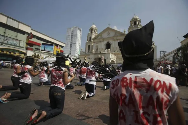 Filipino protesters kneel as they imitate flagellants with slogans printed on their shirts during a rally in downtown Manila, Philippines on Holy Wednesday, March 27, 2013. The group staged the protest rally to call on the government for a halt on evictions of poor families illegally occupying land. (Photo by Aaron Favila/AP Photo)