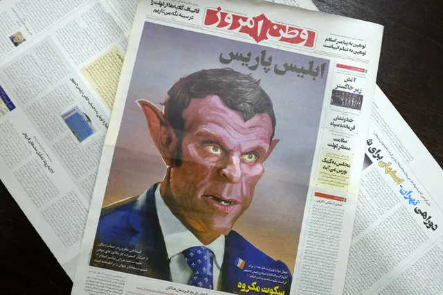 The front page of the Tuesday, October 27, 2020 edition of the Iranian hard-line Iranian newspaper, Vatan-e Emrooz, depicts French President Macron as the devil and called him Satan in a cartoon. Iran summoned a French diplomat to protest Macron's staunch support of secular laws that deem caricatures depicting the Prophet Muhammad as protected under freedom of speech. (Photo by Vahid Salemi/AP Photo)