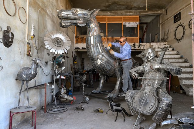 Iranian sculptor Ali Mutii, living in Van, transformed iron collected from scrap dealers into a sculpture of the 'Van Lake Monster' in Van, Turkiye, on July 08, 2025. The sculpture, completed after long efforts and weighing 600 kilograms, was brought to the shore of Van Lake by crane, as it surprises those who saw it. (Photo by Ozkan Bilgin/Anadolu via Getty Images)