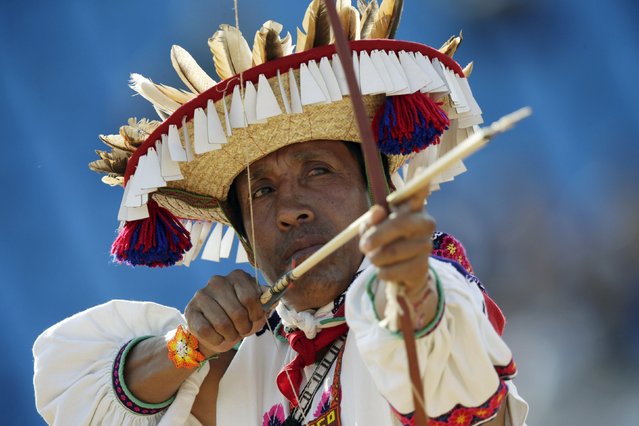 An indigenous man from Mexico fires an arrow during the bow-and-arrow competition at the first World Games for Indigenous Peoples in Palmas, Brazil, October 26, 2015. (Photo by Ueslei Marcelino/Reuters)