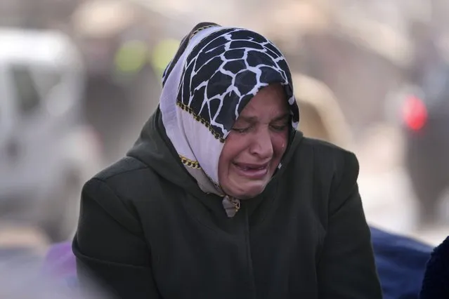 A Turkish woman cries in Kahramanmaras city, southern Turkey, Wednesday, February 15, 2023. Thousands left homeless by a massive earthquake that struck Turkey and Syria a week ago packed into crowded tents or lined up in the streets for hot meals as the desperate search for survivors entered what was likely its last hours. (Photo by Hussein Malla/AP Photo)