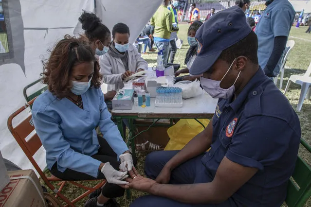 A city compliance official gives blood at a blood drive in support of the country's military, at a stadium in the capital Addis Ababa, Ethiopia Thursday, November 12, 2020. Rallies occurred in multiple cities in support of the federal government's military offensive against the Tigray regional government, the Tigray People's Liberation Front. (Photo by Mulugeta Ayene/AP Photo)