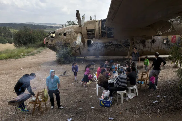 In this April 16, 2013 file photo, an Israeli family gathers for a barbecue next to an old Nord military transport aircraft, to celebrate Israel's 65th independence day, in the Defender's Forest near Kibbutz Nahshon, central Israel. As Israel marks the 70th anniversary of statehood starting at sundown Wednesday, April 18, 2018, satisfaction over its successes and accomplishments share the stage with a grim disquiet over the never-ending conflict with the Palestinians, internal divisions and an uncertain place in a hostile region. (Photo by Oded Balilty/AP Photo)