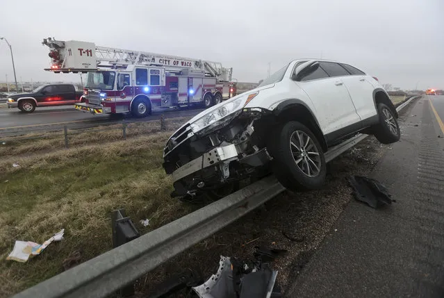 A vehicle rests on a barricade as the driver lost control and slid off Highway 6 on Tuesday January 31, 2023 in Waco, Texas. Winter weather brought ice to Texas and nearby states Tuesday. (Photo by Jerry Larson/Waco Tribune-Herald via AP Photo)
