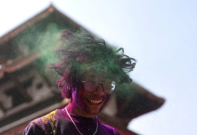 A man reacts while celebrating Holi, the Festival of Colours in Kathmandu, Nepal on March 06, 2023. (Photo by Monika Malla/Reuters)