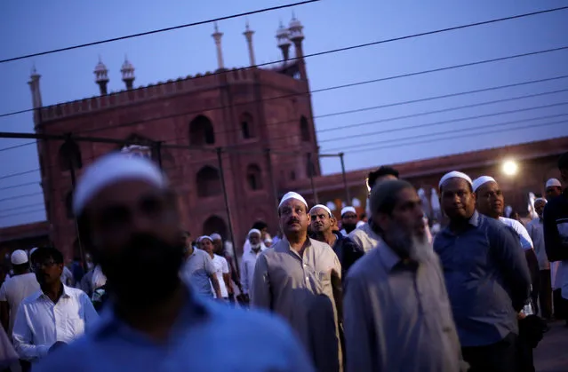 Muslim men look towards the sky to spot the crescent moon, on the eve of the holy fasting month of Ramadan, at the Jama Masjid (Grand Mosque) in the old quarters of Delhi, India, May 16, 2018. (Photo by Adnan Abidi/Reuters)