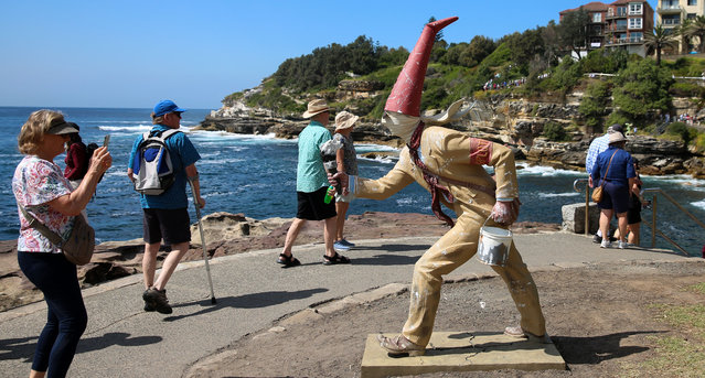 Visitors pass an exhibit for Sculpture by the Sea, along the coastal walk from Bondi to Tamarama in Sydney, Australia on October 24, 2025. The annual event is Australia’s largest annual outdoor sculpture exhibition. (Photo by Xinhua News Agency/Rex Features/Shutterstock)