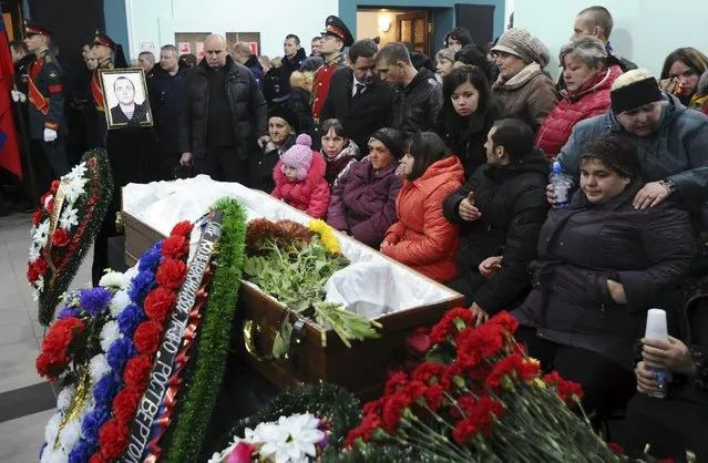 People attend a memorial service before the funeral of Alexander Pozynich, a Russian marine killed during an operation to recover the crew of the downed Su-24 jet, in Novocherkassk, Rostov region, Russia, November 27, 2015. (Photo by Sergey Pivovarov/Reuters)