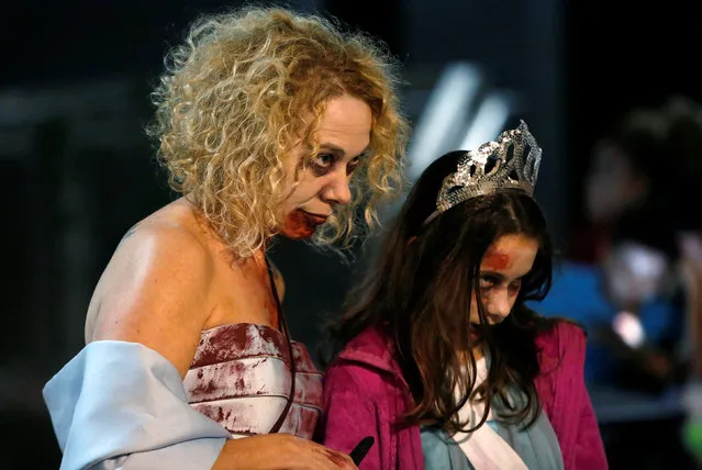 Mother and daughter Zombies take part in the annual Silver Spring Zombie Walk before Halloween in Silver Spring, Maryland, U.S., October 29, 2016. (Photo by Gary Cameron/Reuters)