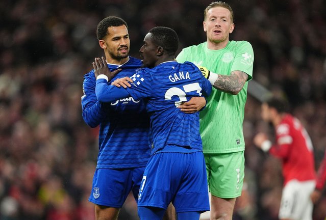 Everton's Idrissa Gueye is held back after a confrontation with team mate Michael Keane, leading to a red card for Gueye during the Premier League match at Old Trafford, Manchester on Monday, November 24, 2025. (Photo by Martin Rickett/PA Images via Getty Images)