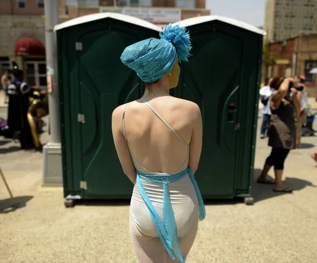 A parade participant arrives in costume for the 31st Annual Mermaid Parade at New York's Coney Island on June 22, 2103. Over 700,00 people are exptected to turn out for the  scantily clad parade.       AFP PHOTO / TIMOTHY CLARY        (Photo credit should read TIMOTHY CLARY/AFP/Getty Images)