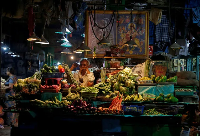 A vendor selling vegetables waits for customers at a market in Kolkata, India, March 27, 2018. (Photo by Rupak De Chowdhuri/Reuters)