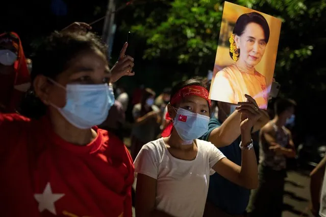 A supporter of National League for Democracy holds a picture of Myanmar State Counselor Aung San Suu Kyi as she waits for results outside the party headquarters after the general election in Yangon, Myanmar, November 8, 2020. (Photo by Shwe Paw Mya Tin/Reuters)