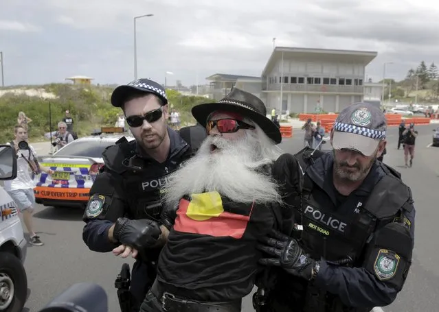 An Aboriginal protester is detained by Australian police during demonstrations on the 10th anniversary of race riots in Sydney's beachside suburb of Cronulla, December 12, 2015. In December 2005, racially charged tension between residents from the largely white beachside neighbourhood and Muslim youths from western Sydney degenerated in days of riots involving thousands of people. (Photo by Jason Reed/Reuters)