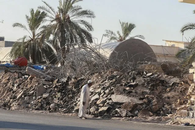 A man walks past the rubble of a demolished al-Siraji Mosque in Basra, Iraq, on Monday, July 17, 2023. An official said the old mosque would be replaced with a modern, better-designed one that would not impede traffic flow. (Photo by Nabil al-Jurani/AP Photo)