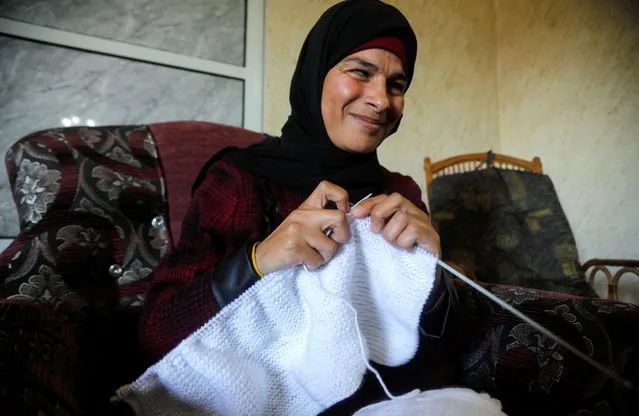 Blind Palestinian woman Kefah Damra, who knits woolen products with her blind sister Hanan to make a living, works at their home in Kafr ad-Dik near Salfit in the Israeli-occupied West Bank on February 15, 2021. (Photo by Raneen Sawafta/Reuters)