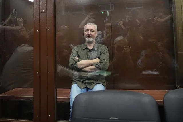 Igor Girkin (Strelkov), the former top military commander of the self-proclaimed “Donetsk People's Republic” and nationalist blogger, detained earlier Friday and accused of extremism, sits inside a glass defendants' cage during a hearing to consider a request on his pre-trial arrest in Moscow on July 21, 2023. (Photo by Alexander Zemlianichenko/Pool via AFP Photo)
