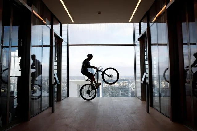 French professional mountain biker Aurelien Fontenoy climbs the 768 steps, 33 flors and 140 metres high Trinity Tower in the financial and business district of La Defense near Paris, France, January 17, 2021. (Photo by Gonzalo Fuentes/Reuters)