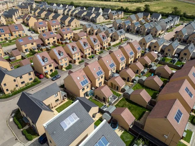 An aerial shot of newly-built houses pictured from a drone on July 26, 2023 in Northstowe, England. The newly-built sustainable Cambridgeshire town of Northstowe will eventually see 10,000 new homes housing around 26,000 people and is Britain's biggest development in almost 60 years. However, six years after residents first moved moved in it still has no shops, cafes, GP surgery or dentist, leading to dissatisfaction among residents with 76 percent stating they were either “fairly” or “very dissatisfied” in a Cambridgeshire County Council survey about the area. (Photo by Carl Court/Getty Images)