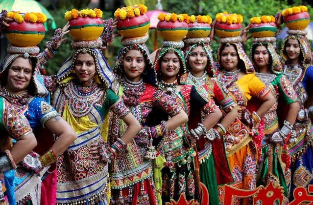 Women pose for pictures during rehearsals for Garba, a folk dance, ahead of Navratri, a festival during which devotees worship the Hindu goddess Durga and youths dance in traditional costumes, in Ahmedabad, India October 5, 2018. (Photo by Amit Dave/Reuters)