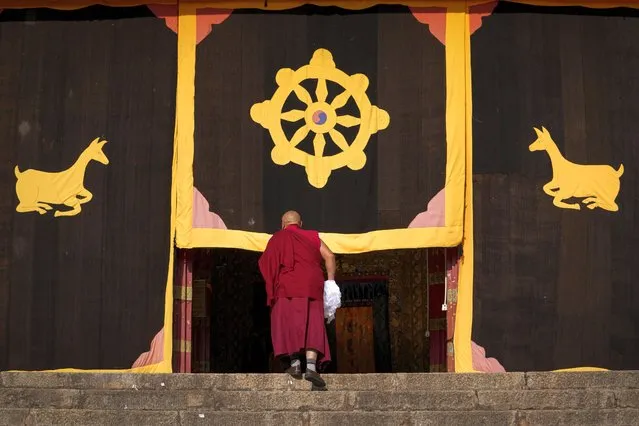 A Tibetan monk walks into the Sangpiling Monastery in Xiangcheng county, Ganzi Tibetan Autonomous Prefecture of southwestern China's Sichuan province, Thursday, September 7, 2023. (Photo by Andy Wong/AP Photo)