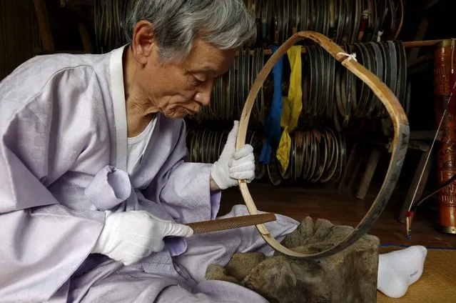 South Korean traditional bow artisan Kwon Yeong-Hak works on a bow in his workshop in Yecheon-gun, Gyeongsangbuk-do, South Korea, 26 February 2015. (Photo by Jeon Heon-Kyun/EPA)