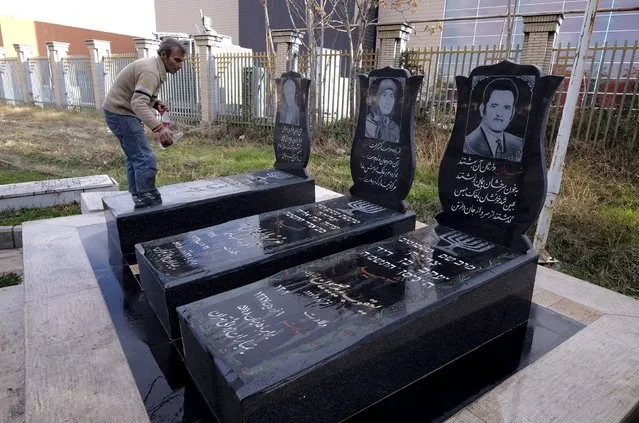 A man washes gravestones of Jews who were killed in Iran-Iraq war (1980-88) at the Beheshtieh Jewish Cemetery in Tehran January 1, 2016. The cemetery of the Jew community in Tehran was established in 1937. Thousands of Jews have been buried there, including those killed in the war. (Photo by Raheb Homavandi/Reuters/TIMA)