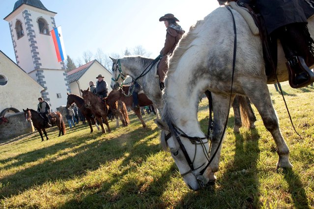 Riders wait for their horses to be blessed by a priest on St. Stephen's day in Srednja Vas, Slovenia December 26, 2016. (Photo by Srdjan Zivulovic/Reuters)
