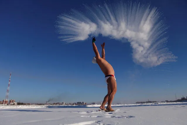 A winter swim lover throws hot water into cold air in Heihe, Heilongjiang province, China, December 27, 2016. (Photo by Reuters/Stringer)