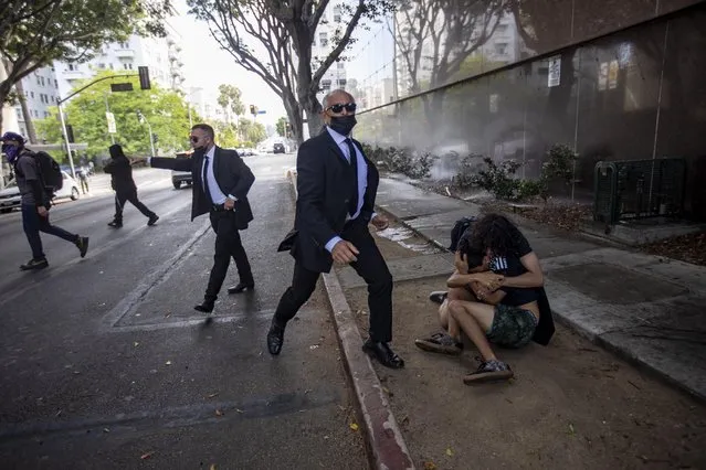 Wi Spa security intervenes after a counter-protester was chased at the protest in support of transgender rights outside the Wi Spa in the Koreatown area of Los Angeles on July 3, 2021 in support of the business after a viral video complained that they allowed a transgender woman in the spa. (Photo by Jill Connelly/ZUMA Wire/Rex Features/Shutterstock)