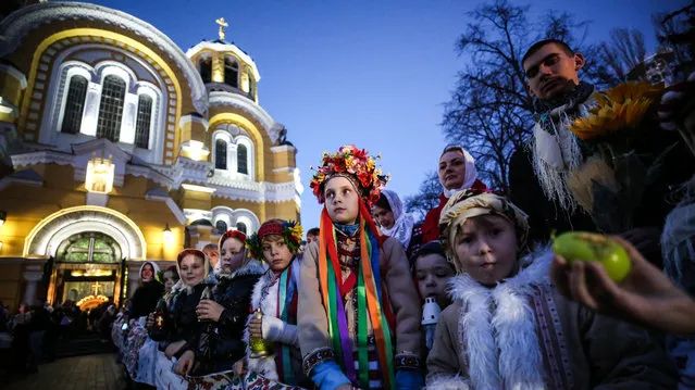 Children wait for the Holy Fire, a flame lit in Jerusalem and passed from candle to candle, to arrive at the Cathedral of St. Volodymyr in Kyiv on Easter night, April 7, 2018. (Photo by Serhii Nuzhnenko/Radio Free Europe/Radio Liberty)