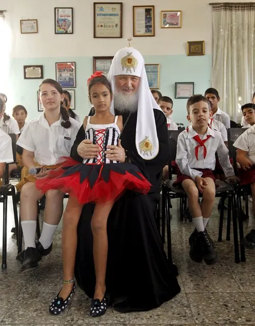 Patriarch Kirill, the head of the Russian Orthodox Church (C), poses with children at the special needs school “Solidaridad con Panama” (Solidarity with Panama) in Havana, February 13, 2016. (Photo by Ernesto Mastrascusa/Reuters)