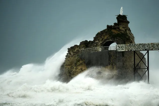 This photograph taken on November 3, 2023, shows waves crashing on the “Rocher de La Vierge” (Virgin Rock) as Storm Ciaran hits the region, in Biarritz, southwestern France . At least 12 people were killed as Storm Ciaran battered Western Europe with record winds of up to 200 kilometres per hour, causing travel mayhem with closed ports and flight and rail disruptions. The French weather service said storms would continue into November 3, notably in the southwest of the country and on the island of Corsica. (Photo by Gaizka Iroz/AFP Photo)