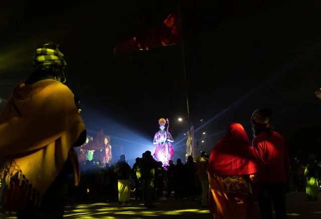 Hindu devotees watch a light show on the eve of the Hindu Lord Ram temple opening in Ayodhya, in India on January 21, 2024. (Photo by Adnan Abidi/Reuters)