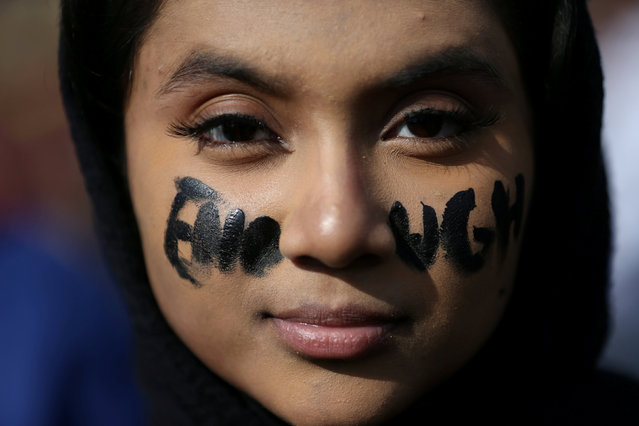 17-year-old Farhana Islam of Albert Einstein high school in Kensington, Maryland demonstrates with other high school students outside the U.S. Capitol building with the word “ENOUGH” written across her face during a walk out protest over a lack of U.S. federal government action and legislation on gun violence and school shootings in Washington, U.S., March 14, 2019. (Photo by Leah Millis/Reuters)