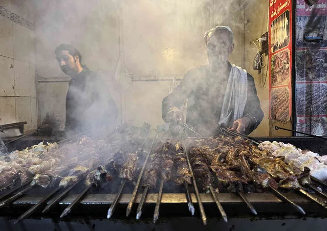 A Pakistani man, right, prepares to make a famous food “Kabab” at a restaurant in Islamabad, Pakistan, Tuesday, January 16, 2024. (Photo by Rahmat Gul/AP Photo)