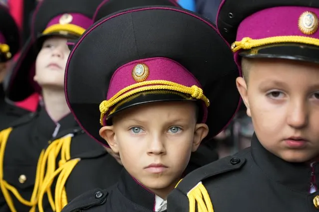 Young cadets attend a ceremony on the occasion of the first day of school at a cadet lyceum in Kyiv, Ukraine, Wednesday, September 1, 2021. Ukraine marks Sept. 1 as Knowledge Day, as a traditional launch of the academic year. (Photo by Efrem Lukatsky/AP Photo)