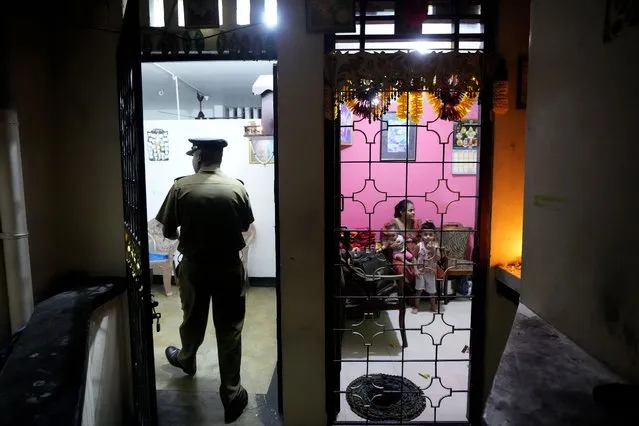 A Sri Lankan police officer enters a house to search for proscribed items during a search operation against narcotics in Colombo, Sri Lanka, Thursday, January 18, 2024. (Photo by Eranga Jayawardena/AP Photo)