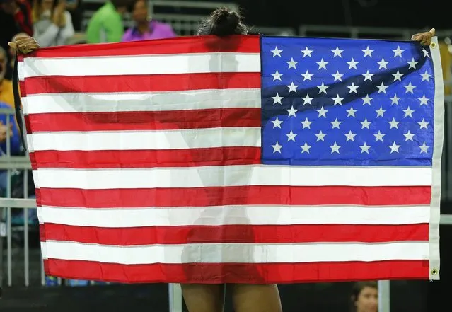 Bronze medalist Quanera Hayes of the U.S. holds up an  American flag as she celebrates after the women's 400 meters final at the IAAF World Indoor Athletics Championships in Portland, Oregon March 19, 2016. (Photo by Mike Blake/Reuters)