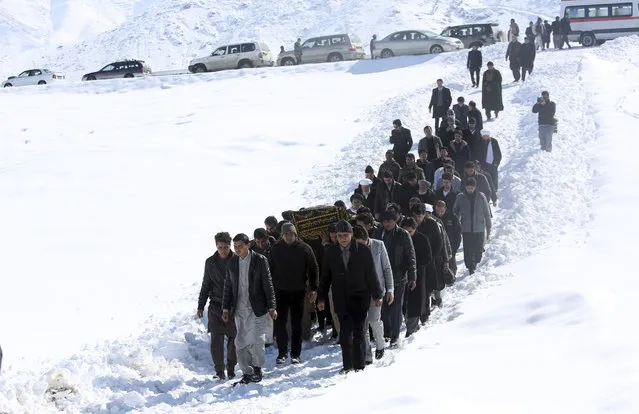 Men carry the coffin of a relative who died in a suicide attack on the Supreme Court in Kabul, Afghanistan, Wednesday, February 8, 2017. A suicide bomber on Tuesday targeted the Supreme Court building in the Afghan capital, Kabul, killing at least 19 people. (Photo by Rahmat Gul/AP Photo)