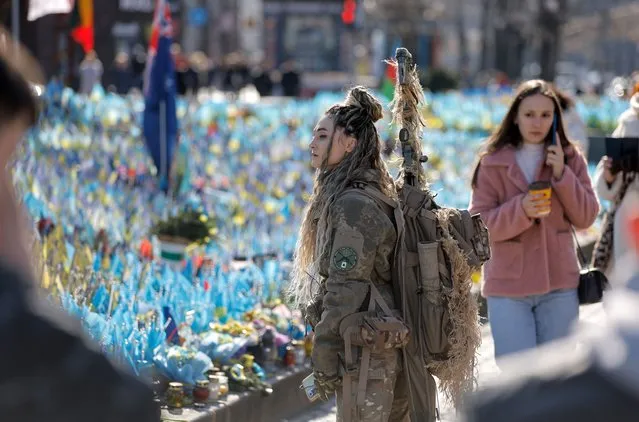 Ukrainian servicewoman nicknamed “Bullet”, who has served in the army for more than one year, stands in front of Ukrainian national flags commemorating the fallen Ukrainian soldiers, at Independence Square on the occasion of International Women's Day in downtown Kyiv, Ukraine, 08 March 2024, amid the Russian invasion. International Women's Day is observed annually worldwide on 08 March to highlight women's rights and bring attention to issues such as gender equality, abuse and violence against women and girls. (Photo by Sergey Dolzhenko/EPA/EFE)