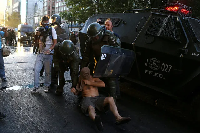 A protester is detained during a rally marking the anniversary of the death of workers union leader Juan Pablo Jimenez, in Santiago, Chile February 21, 2017. (Photo by Ivan Alvarado/Reuters)