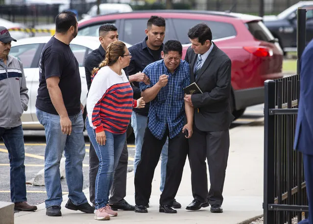 Arnulfo Ochoa, the father of Marlen Ochoa-Lopez, is surrounded by family members and supporters, as he walks into the Cook County medical examiner's office to identify his daughter's body, Thursday, May 16, 2019 in Chicago. (Photo by Ashlee Rezin/Chicago Sun-Times via AP Photo)