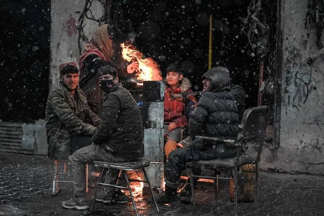 Youths enjoy the first snow in Kabul on December 15, 2021. (Photo by Mohd Rasfan/AFP Photo)