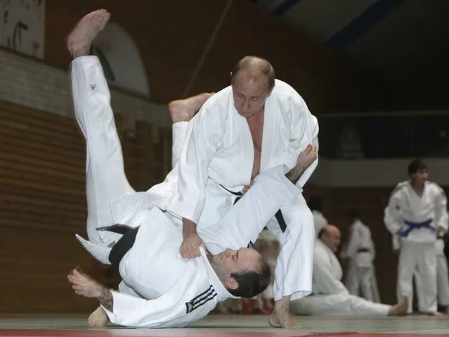 Vladimir Putin, right, conducts a judo training session at Top Athletic School during his working visit to St Petersburg, 18 December 2009. (Photo by Alexei Druzhinin/AFP Photo/RIA Novosti)