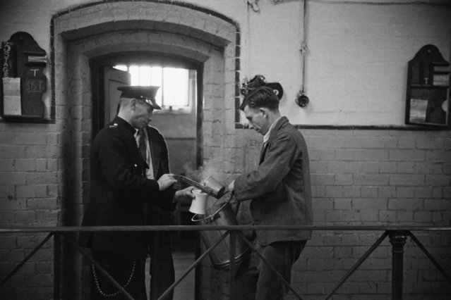 Prison officer Davidson serving a prisoner a meal at Strangeways Prison in Manchester, UK on November 1948. (Photo by Bert Hardy/Picture Post/Hulton Archive/Getty Images)