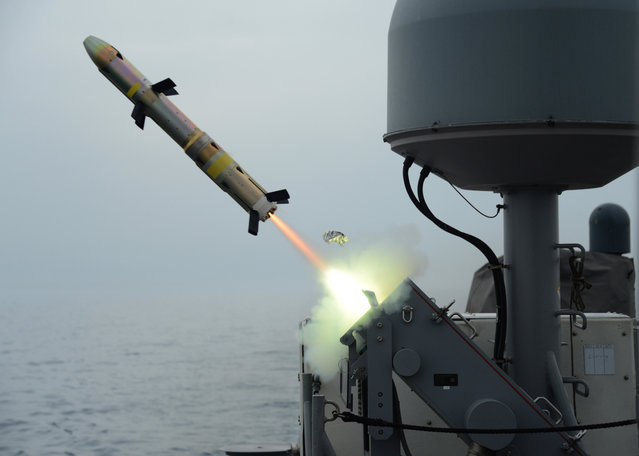 In this photo released on March 20, 2014 by the U.S. Navy, patrol coastal ship USS Typhoon launches a surface-to-surface missile during Griffin missile exercise to guard against small boat threats in the U.S. 5th Fleet Area of responsibility. (Photo by Mass Communication Specialist 1st Class Doug Harvey/U.S. Navy via AP Photo)